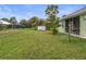 Private backyard with grassy area and storage shed at 2262 Sagebloom Ter, North Port, FL 34286