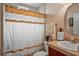 Bathroom boasts a shower/tub combo, granite vanity, and updated fixtures at 2262 Sagebloom Ter, North Port, FL 34286