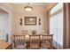 Bright dining room with a wooden table and four chairs at 2262 Sagebloom Ter, North Port, FL 34286