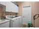 Convenient laundry room with washer, dryer, and cabinets at 2262 Sagebloom Ter, North Port, FL 34286