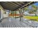 Covered back patio with wood deck and backyard view at 2522 Krueger Ln, Tampa, FL 33618