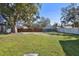 Spacious backyard with grassy area and large tree at 2522 Krueger Ln, Tampa, FL 33618