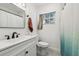 Updated bathroom with white vanity, hex tile floor and a walk-in shower at 2522 Krueger Ln, Tampa, FL 33618