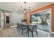 Modern dining room with a large table, six chairs, and an open view to the kitchen and backyard at 2522 Krueger Ln, Tampa, FL 33618