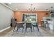 Modern dining room with a large table, six chairs, and an open view to the kitchen at 2522 Krueger Ln, Tampa, FL 33618