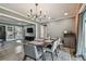 Modern dining room with a large table, six chairs, and an open view to the kitchen and backyard at 2522 Krueger Ln, Tampa, FL 33618