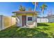 Small storage shed in backyard with a damaged door at 2522 Krueger Ln, Tampa, FL 33618