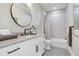 Clean bathroom with white vanity, bathtub, and gray tile at 2623 S Parkview St, Tampa, FL 33629