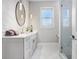 Modern bathroom with walk-in shower, gray cabinets, and marble flooring at 2623 S Parkview St, Tampa, FL 33629