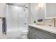 Modern gray bathroom with a walk-in shower and white subway tile at 2623 S Parkview St, Tampa, FL 33629