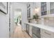 Butler's pantry with white shaker cabinets, quartz countertops, and stainless steel appliances at 2623 S Parkview St, Tampa, FL 33629