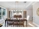 Formal dining room with hardwood floors, a large table, and a stunning chandelier at 2623 S Parkview St, Tampa, FL 33629