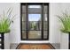 Stylish black modern front door with glass panels and a welcoming mat at 2623 S Parkview St, Tampa, FL 33629