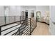 Modern light hallway with hardwood floors and metal railings at 2623 S Parkview St, Tampa, FL 33629