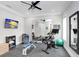 Home gym featuring stationary bikes, weights, and a large mirror at 2623 S Parkview St, Tampa, FL 33629