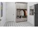 Laundry room with gray cabinets, geometric tile floors, and built-in storage at 2623 S Parkview St, Tampa, FL 33629