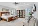 Main bedroom with leather bed, seating area, and hardwood floors at 2623 S Parkview St, Tampa, FL 33629