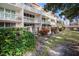 Exterior view of the building, showing the balconies and landscaping at 2635 Seville Blvd # 109, Clearwater, FL 33764