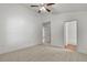 Bright bedroom with carpeted floors, ceiling fan, and access to en-suite bathroom at 28643 Seashell Ct, Wesley Chapel, FL 33545