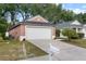 Charming single-Gathering home with a two-car garage, nice lawn, and mature landscaping at 28643 Seashell Ct, Wesley Chapel, FL 33545