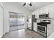 Bright kitchen with stainless steel appliances and sliding glass doors to a fenced yard at 28643 Seashell Ct, Wesley Chapel, FL 33545