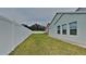 Side yard view with privacy fence and green lawn at 29325 Birds Eye Dr, Wesley Chapel, FL 33543