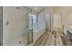 Main bathroom with shower, tub, and walk-in closet access at 29325 Birds Eye Dr, Wesley Chapel, FL 33543