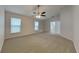 Large main bedroom with carpet and ceiling fan at 29325 Birds Eye Dr, Wesley Chapel, FL 33543