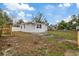 Large backyard with wooden fence and area for landscaping at 303 E 120Th Ave, Tampa, FL 33612