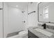 Updated bathroom with a walk-in shower, modern vanity, and stylish finishes at 303 E 120Th Ave, Tampa, FL 33612