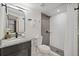 Modern bathroom with a large walk-in shower, granite vanity, and updated fixtures at 303 E 120Th Ave, Tampa, FL 33612