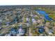 Aerial view of a neighborhood with mature trees, water access, and the property's central location at 3075 Rosery Ne Rd, Largo, FL 33771