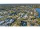 Aerial view of the neighborhood showcasing mature trees, water access, and the property's location at 3075 Rosery Ne Rd, Largo, FL 33771