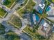 Aerial view of a home with a screened pool, large yard and mature landscaping at 3075 Rosery Ne Rd, Largo, FL 33771