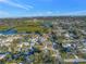 This aerial view showcases the property's location near a waterway and lush greenery at 3075 Rosery Ne Rd, Largo, FL 33771