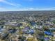 Overhead shot of neighborhood street with mature trees and tidy landscaping and swimming pools at 3075 Rosery Ne Rd, Largo, FL 33771