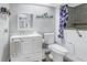 Bright bathroom featuring a white vanity, toilet, walk-in bathtub, and coastal-themed decor at 3075 Rosery Ne Rd, Largo, FL 33771