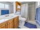 Bathroom featuring a vanity, toilet, and shower with curtain at 3075 Rosery Ne Rd, Largo, FL 33771