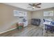 Comfortable bedroom with hardwood floors, a ceiling fan, and natural light from two windows at 3075 Rosery Ne Rd, Largo, FL 33771