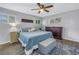 Serene bedroom with a comfortable bed, ceiling fan, and natural light from the windows at 3075 Rosery Ne Rd, Largo, FL 33771