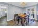 Dining area with a wooden table, chairs, stools and access to an enclosed, screened back porch through double doors at 3075 Rosery Ne Rd, Largo, FL 33771