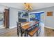 Cozy dining room next to an open kitchen, with wood floors, a chandelier, and natural light at 3075 Rosery Ne Rd, Largo, FL 33771