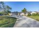 Charming single-story home features a spacious driveway and a well-manicured front lawn at 3075 Rosery Ne Rd, Largo, FL 33771