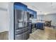 Well-equipped kitchen featuring stainless steel appliances and stylish blue cabinetry at 3075 Rosery Ne Rd, Largo, FL 33771