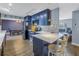 Modern kitchen with blue cabinets, stainless steel appliances, and counter seating at 3075 Rosery Ne Rd, Largo, FL 33771