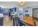 Open kitchen and dining area with blue cabinets, stainless appliances, white countertops and wood laminate flooring at 3075 Rosery Ne Rd, Largo, FL 33771