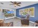 Bright living room with hardwood floors, a ceiling fan, a large window and blue accent wall at 3075 Rosery Ne Rd, Largo, FL 33771