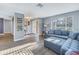 Bright and airy living room with light gray walls, wood-look floors, and a comfortable sectional sofa near the entry at 3075 Rosery Ne Rd, Largo, FL 33771