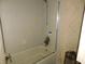 Bathroom with shower/tub combo and tile walls. Needs updating at 3202 Cullendale Dr, Tampa, FL 33618