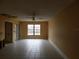 Living room with large window and tile floors. Requires updates at 3202 Cullendale Dr, Tampa, FL 33618